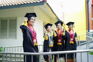 a group of women in graduation gowns standing next to each other